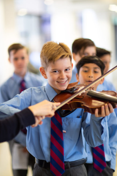 boy leaning to play violin